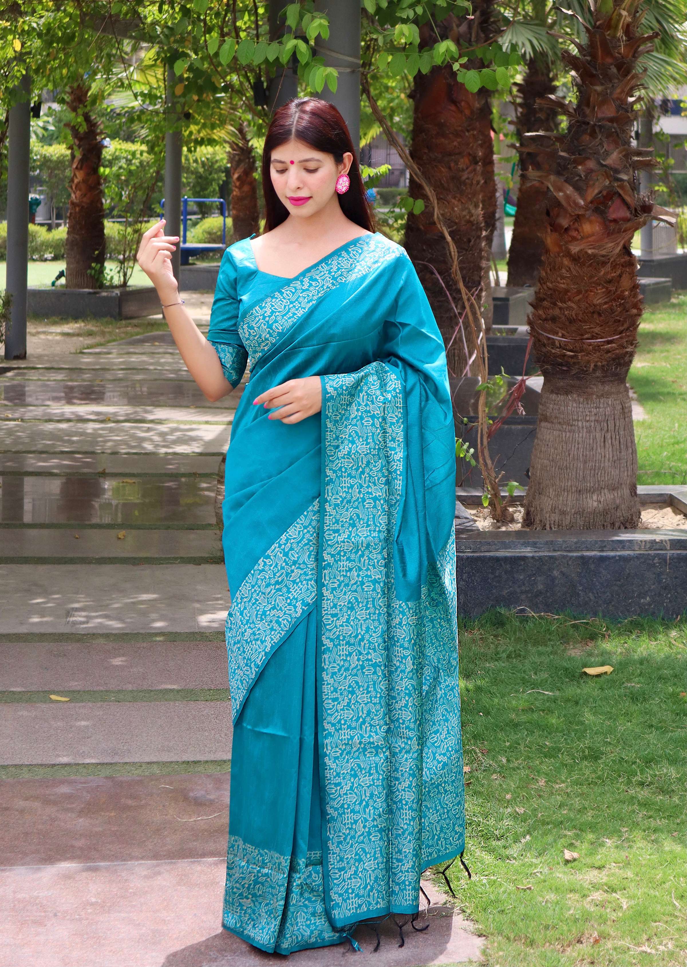 Firozi blue handloom raw silk saree featuring a delicate printed border