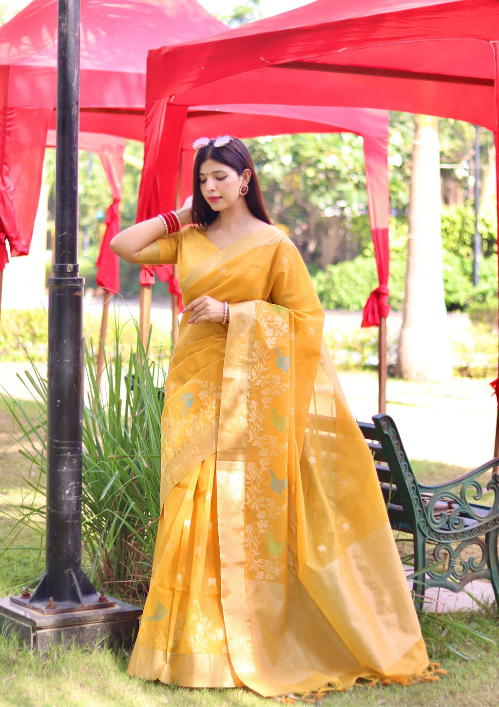 Bright yellow linen silk saree with elegant zari woven details and a blouse piece