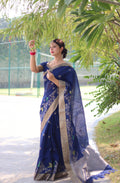 A beautiful blue linen silk traditional saree with intricate zari woven patterns and matching blouse.
