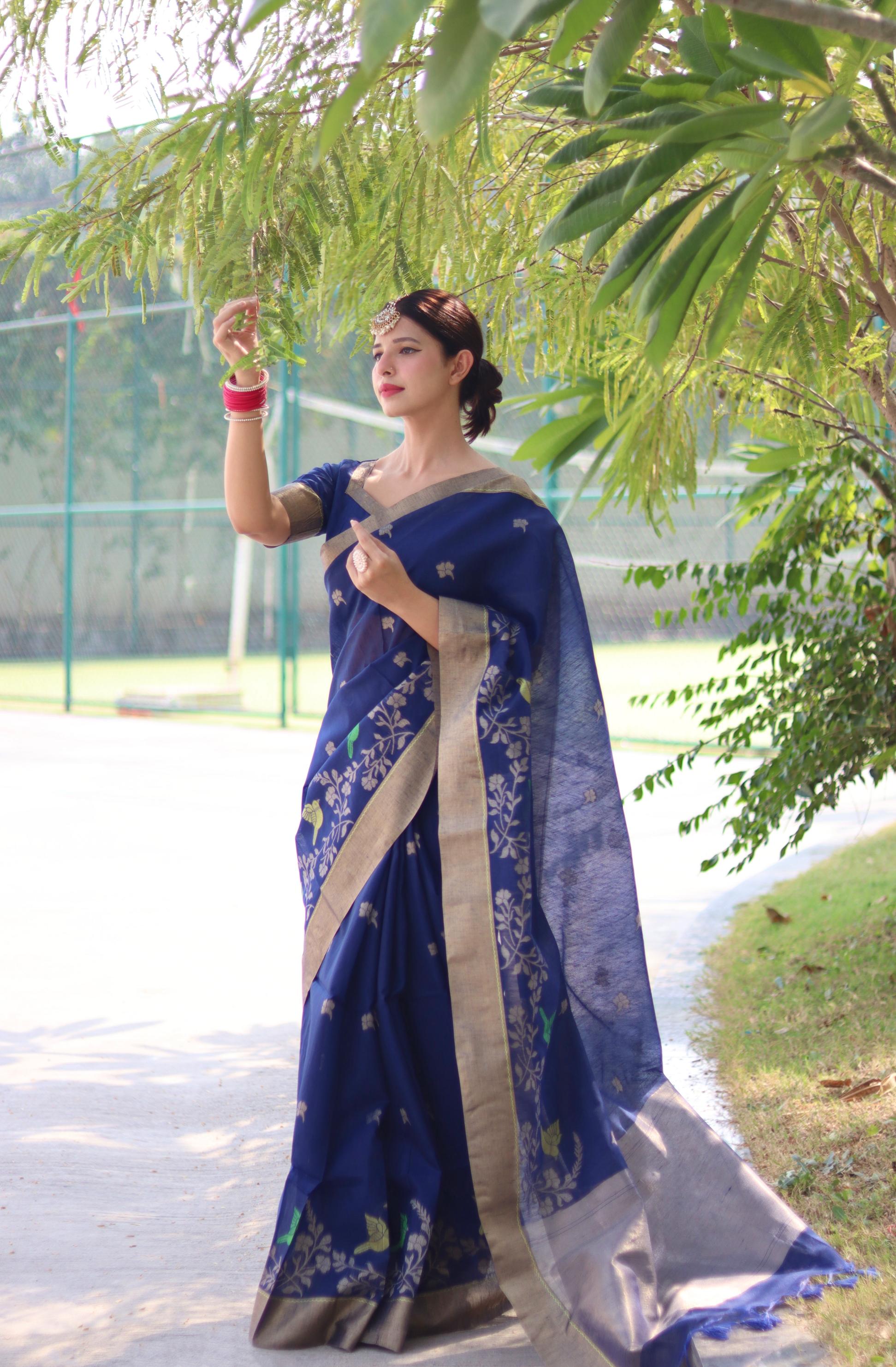A beautiful blue linen silk traditional saree with intricate zari woven patterns and matching blouse.