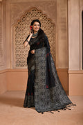 Elegant black handloom raw silk saree with woven pallu design and matching blouse piece