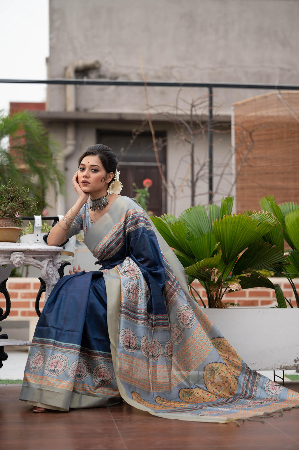 Navy blue soft tussar silk saree with traditional ethnic prints and a gold zari border