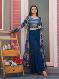 Woman wearing a Teal Blue Georgette Sharara set with sequin choli and printed shrug