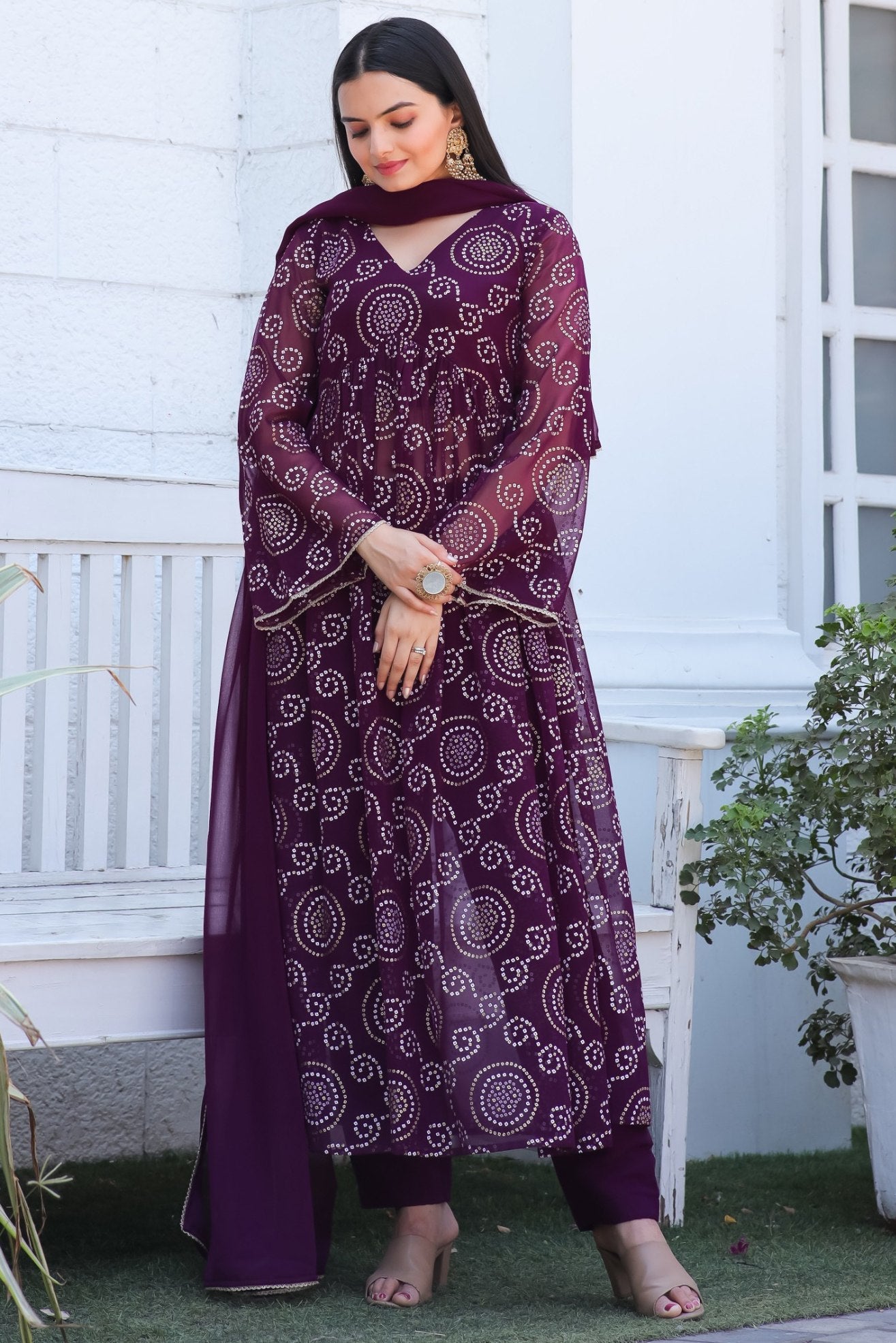 Wine colored Bandhani print georgette kurta set featuring bell sleeves and matching dupatta