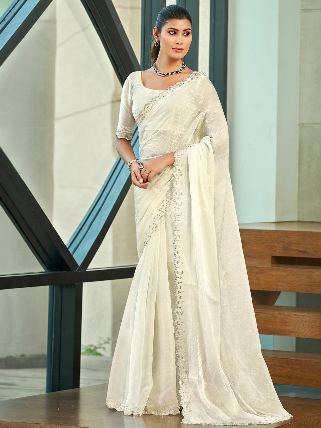 Elegant cream silk blend saree with intricate crystal cutwork and beaded border