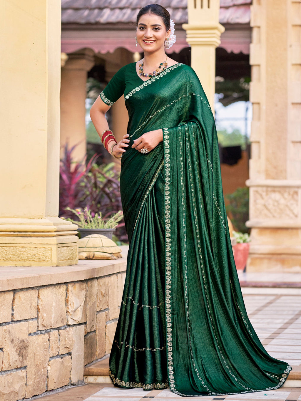Green shimmer chiffon saree with embellished border and crystal detailing.