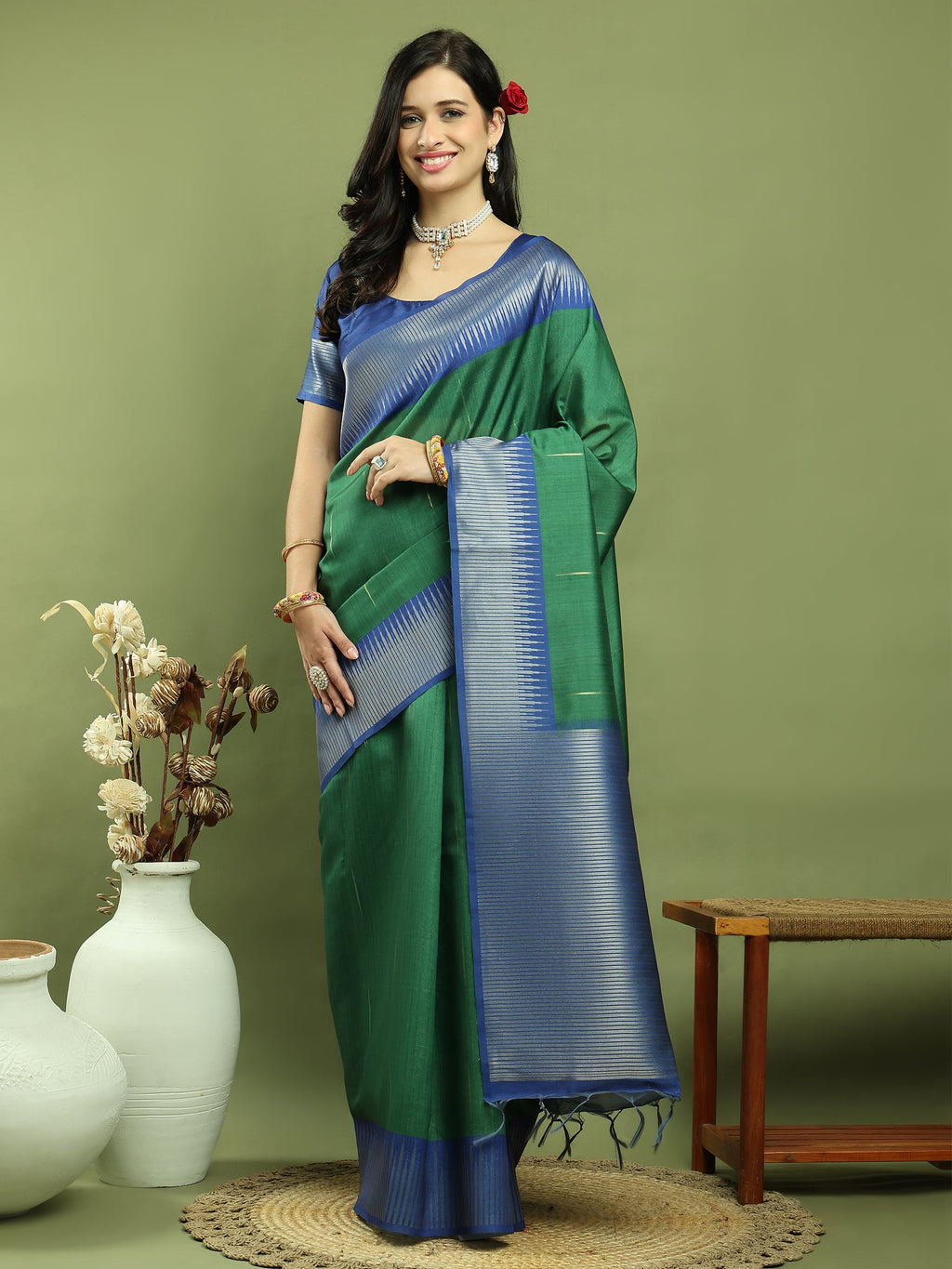 Green silk blend saree with Ikat weaving pattern and jari border drape.