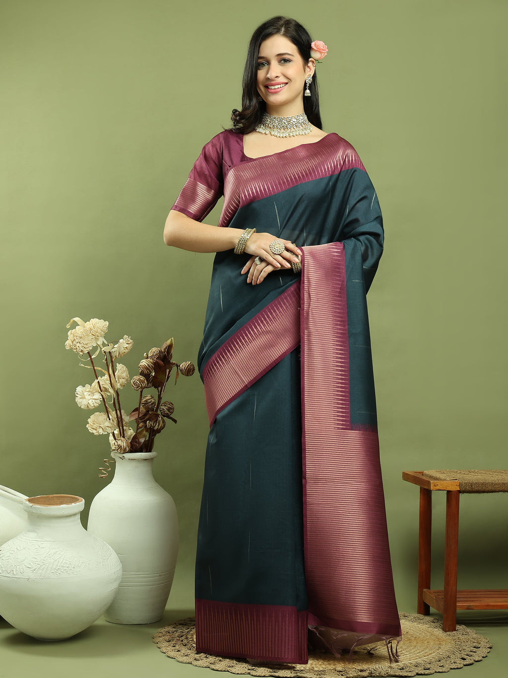 Close up of a Teal silk blend Ikat saree featuring an intricate Jari border and ethnic weaving