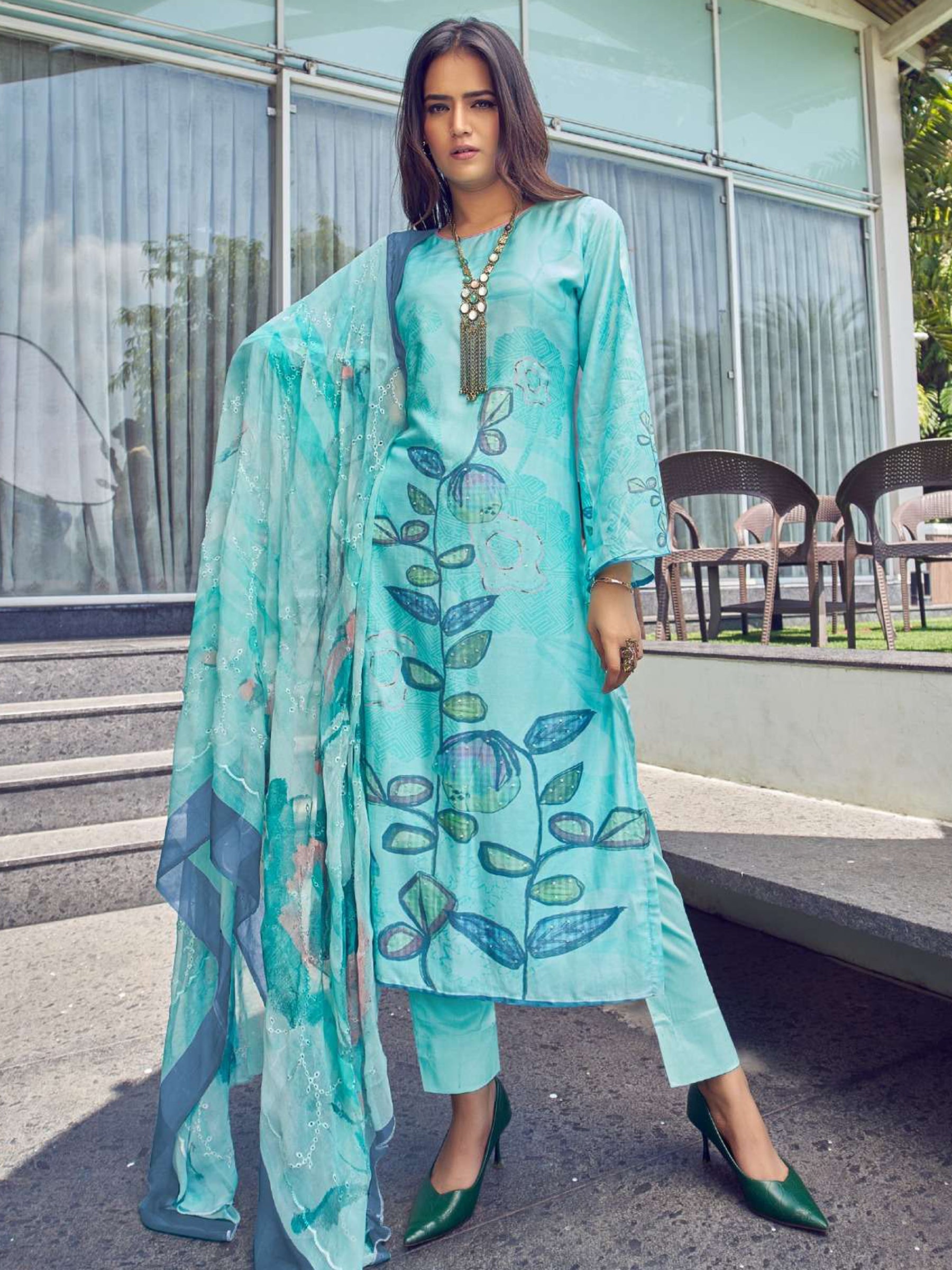 Turquoise muslin salwar suit with floral digital print and sequin embellishments.