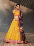 Woman wearing a yellow georgette lehenga choli with heavy zari and sequin embroidery