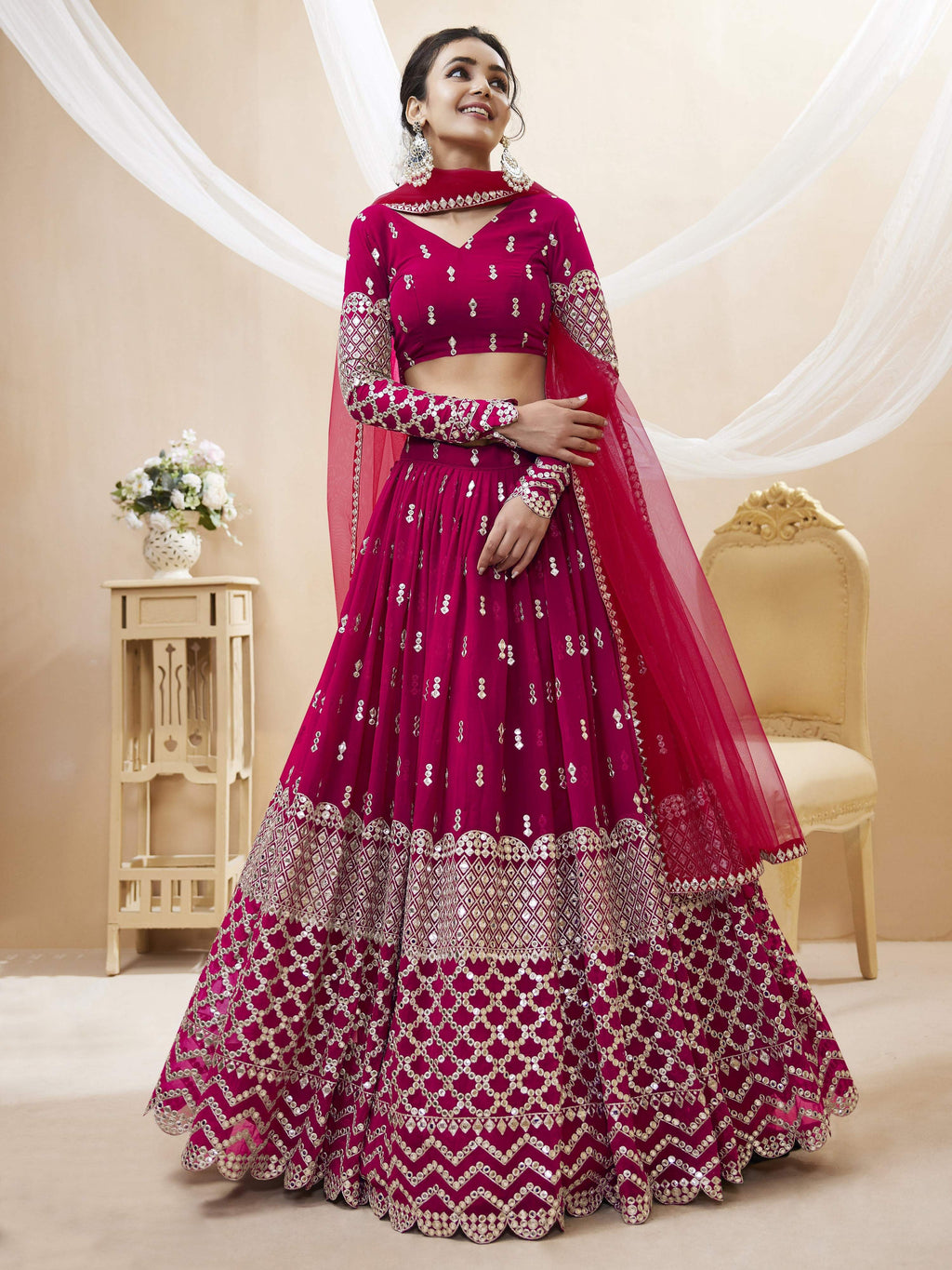 Model wearing a vibrant Hot Pink Georgette lehenga with zari and sequins embroidery