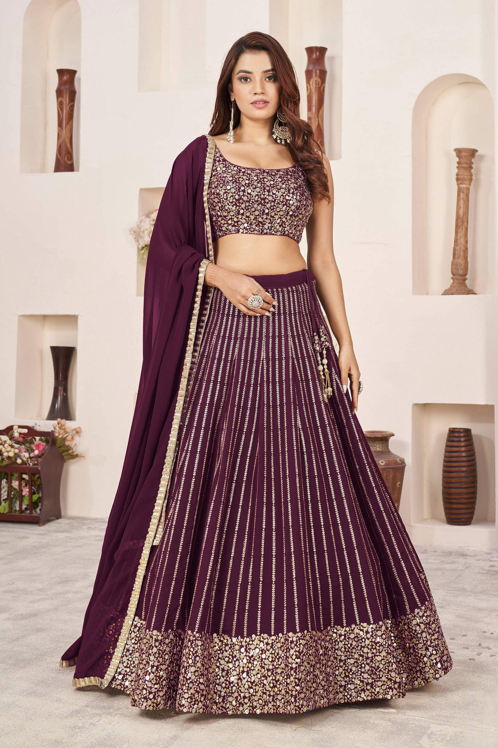 Wine colored Georgette lehenga choli featuring elegant sequins and zari work