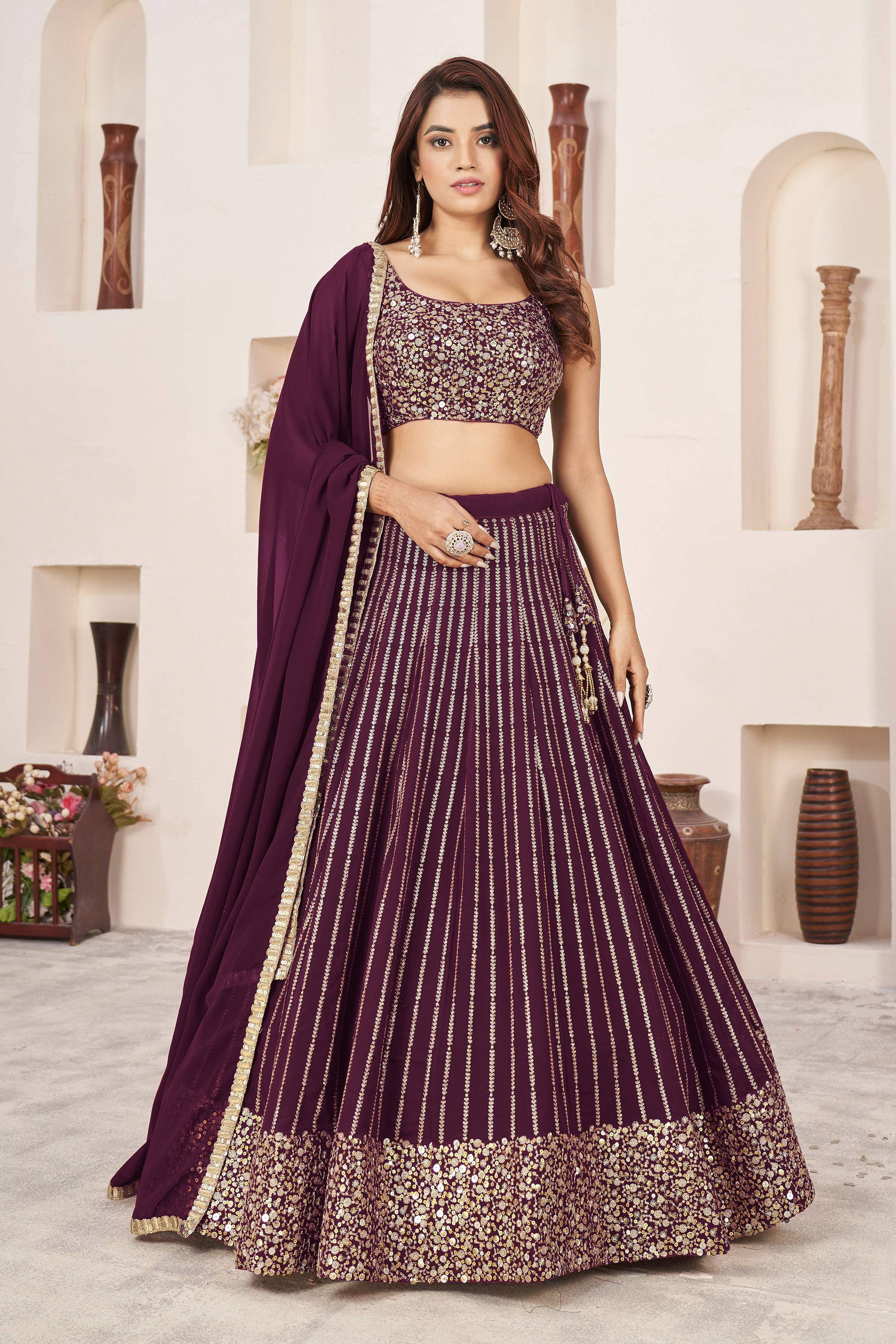 Wine colored Georgette lehenga choli featuring elegant sequins and zari work