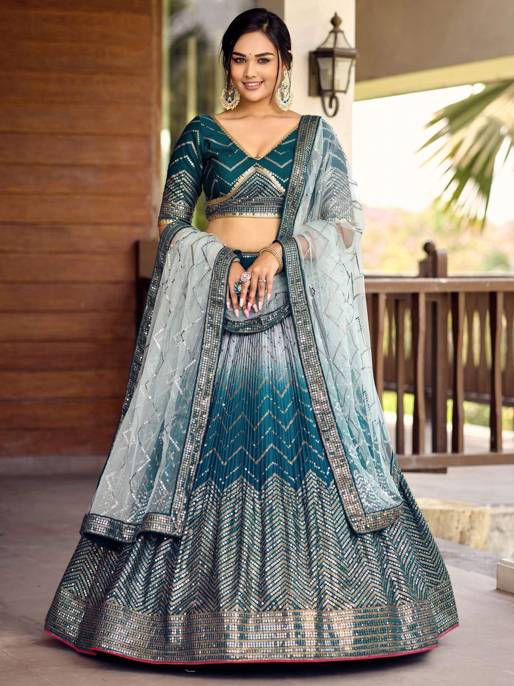 Woman wearing a blue Chinon lehenga choli with sequins and thread embroidery