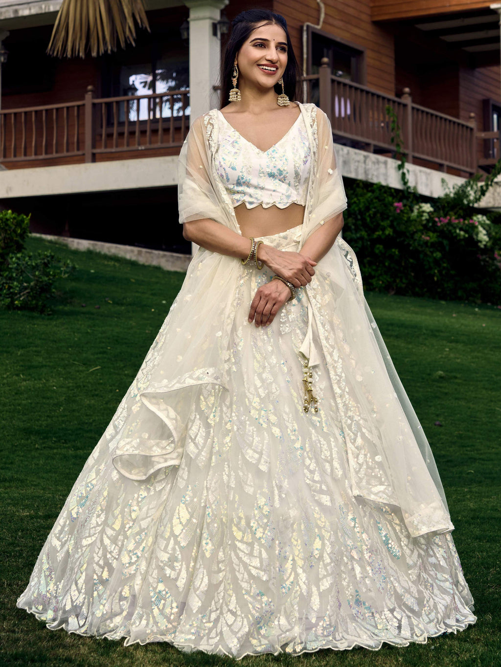 Elegant white soft net lehenga choli with multi-colored sequins and intricate thread embroidery