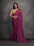 Wine Chiffon saree with intricate prints and mirror work detailing, paired with a matching blouse.