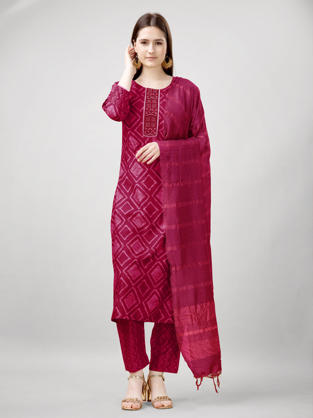 Women wearing a pink straight rayon kurta with floral print and embroidery detail
