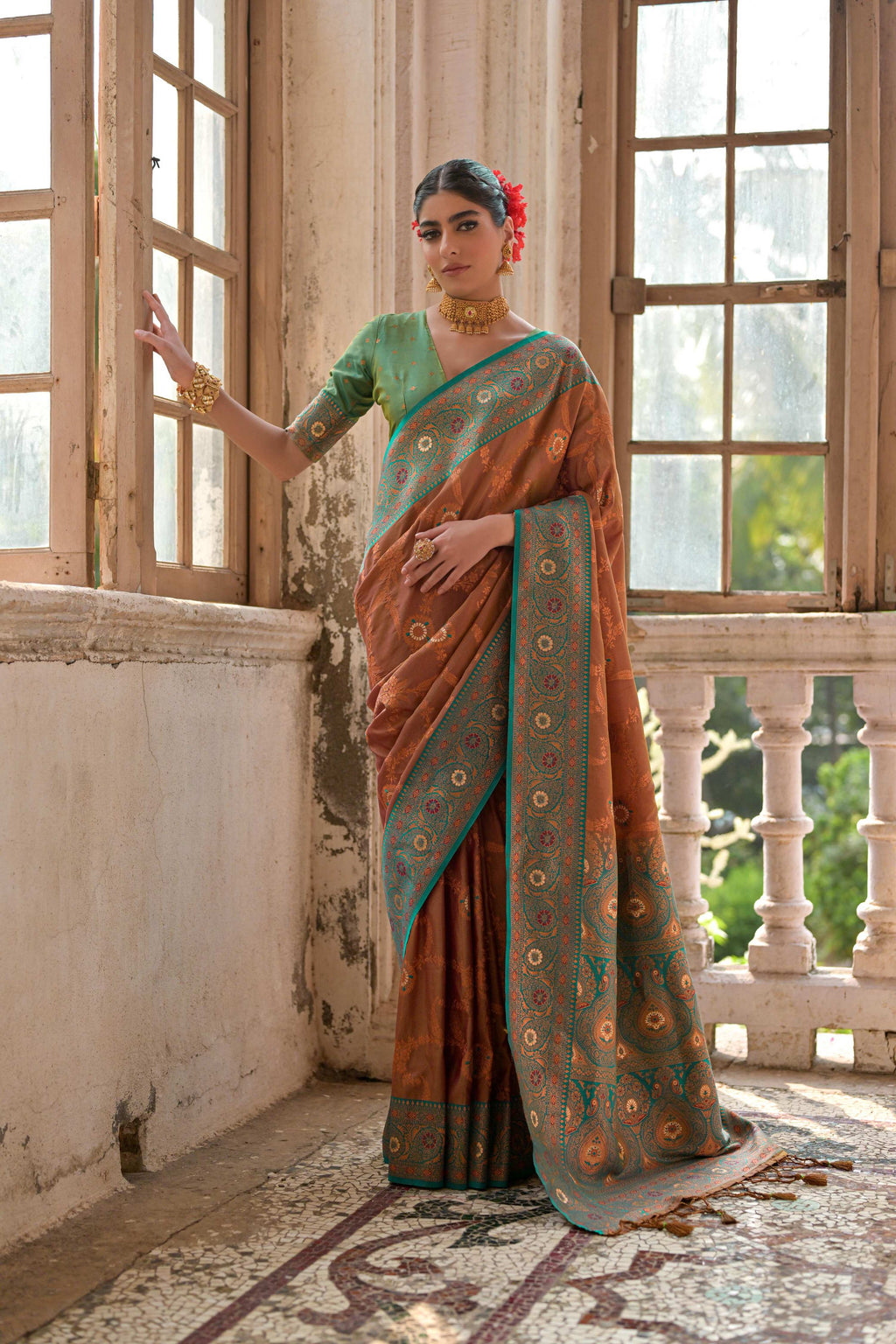 Women wearing a brown Banarasi silk traditional saree with golden zari woven details
