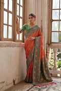 Traditional orange Banarasi Silk saree with golden Zari woven patterns