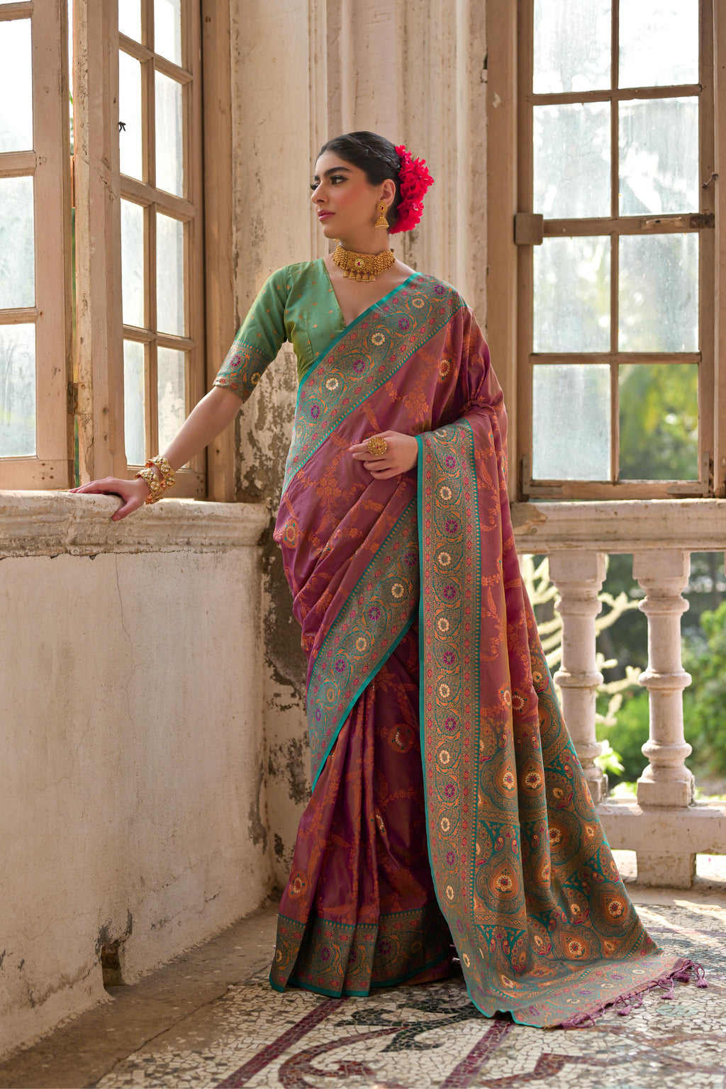 Woman wearing a Wine Banarasi Silk Zari woven traditional saree with matching blouse