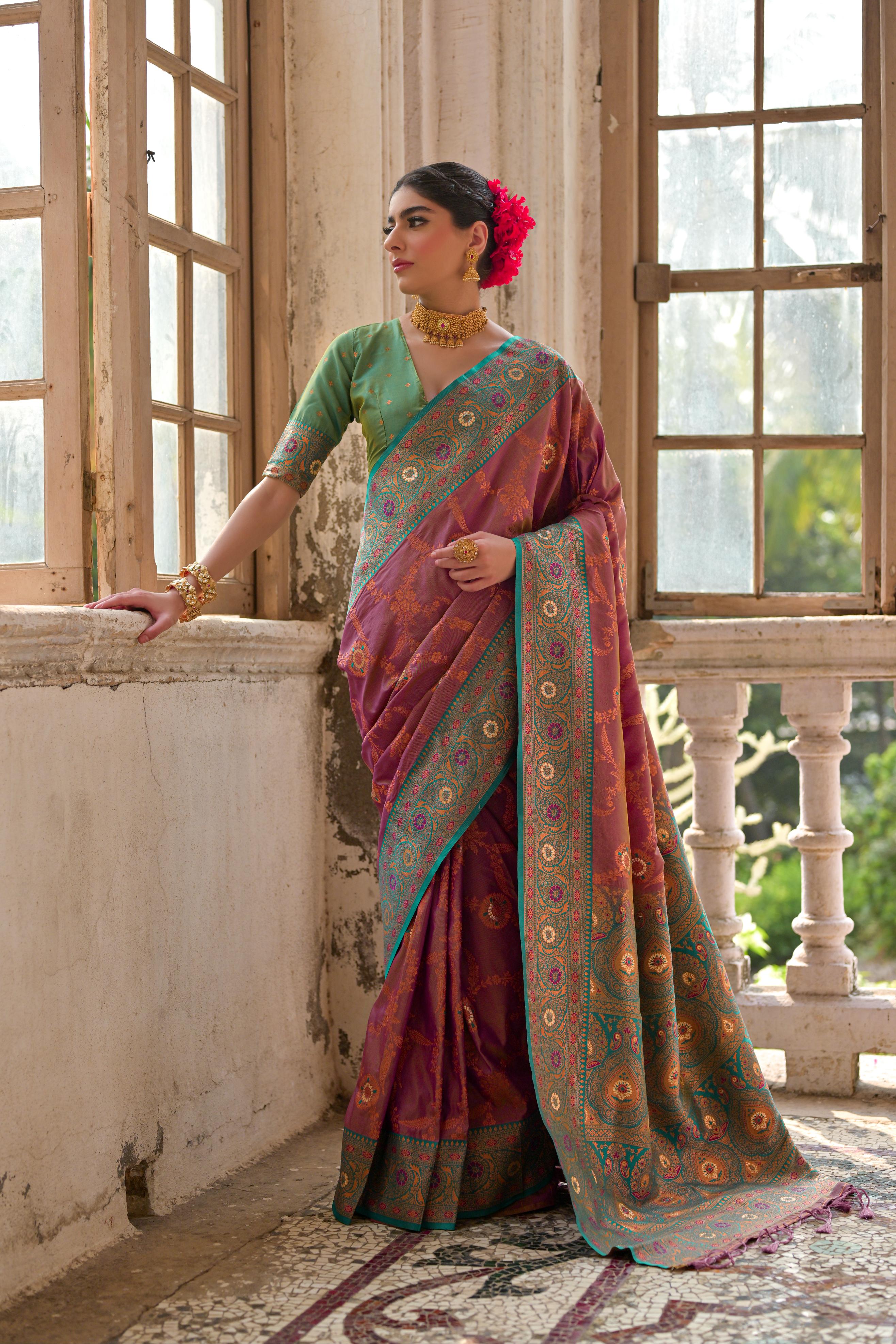Woman wearing a Wine Banarasi Silk Zari woven traditional saree with matching blouse