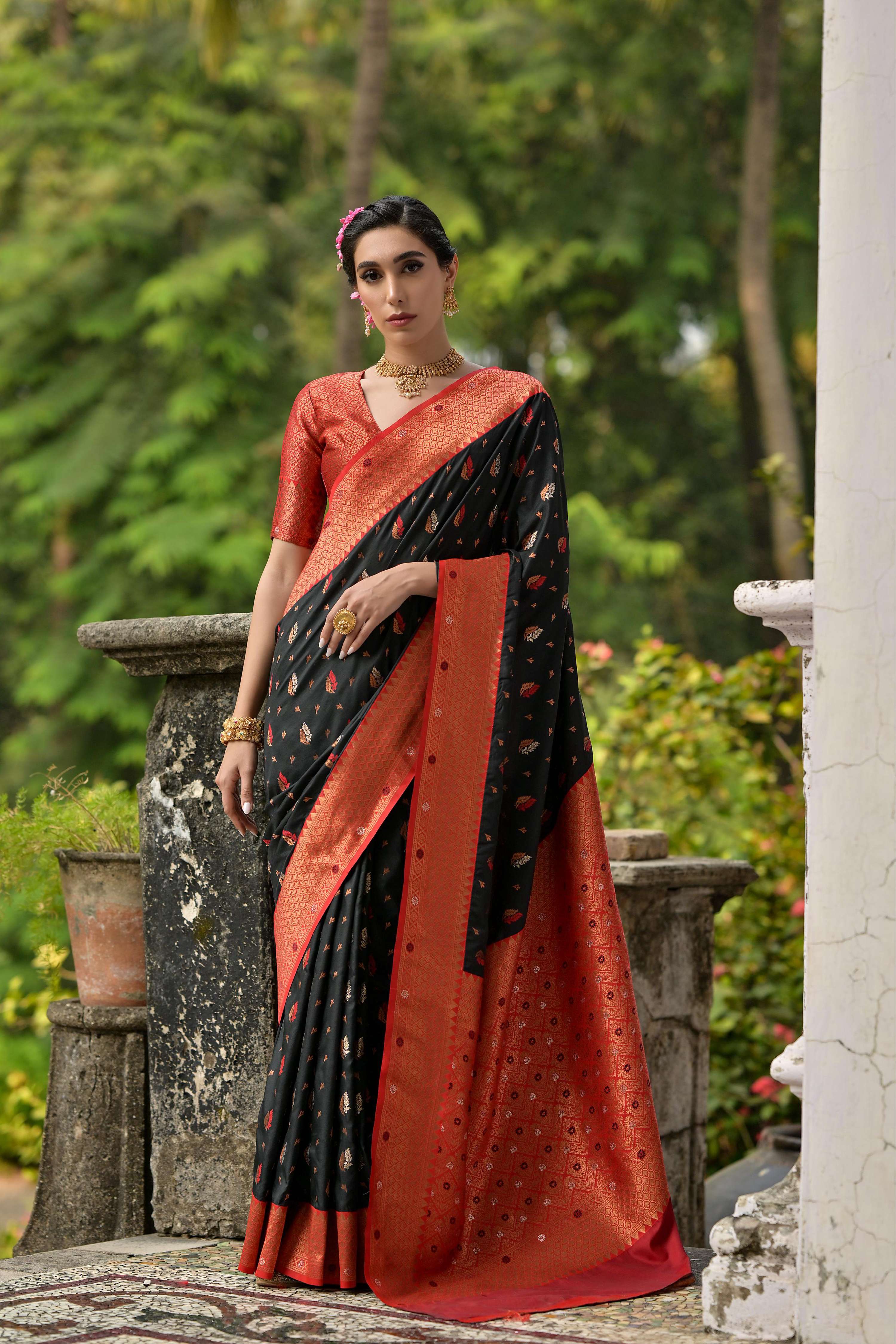 Black Banarasi silk saree with intricate gold Zari woven border and matching blouse piece.