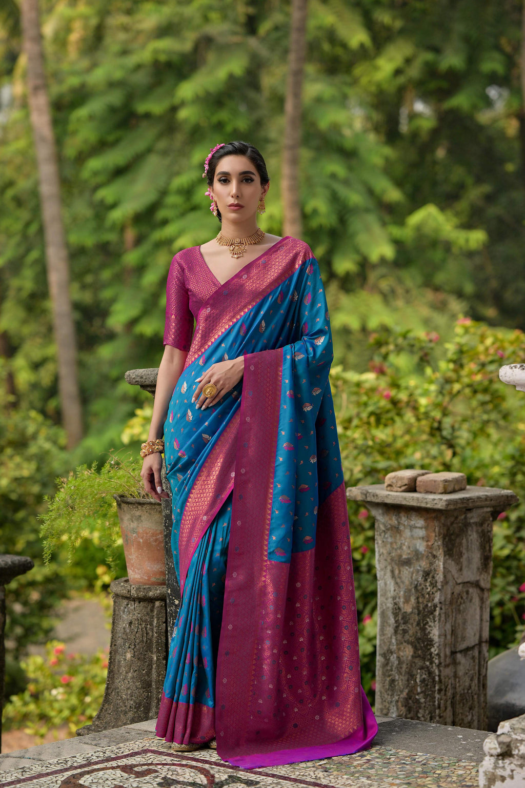 A beautiful blue Banarasi silk saree with traditional gold Zari woven patterns and matching blouse.