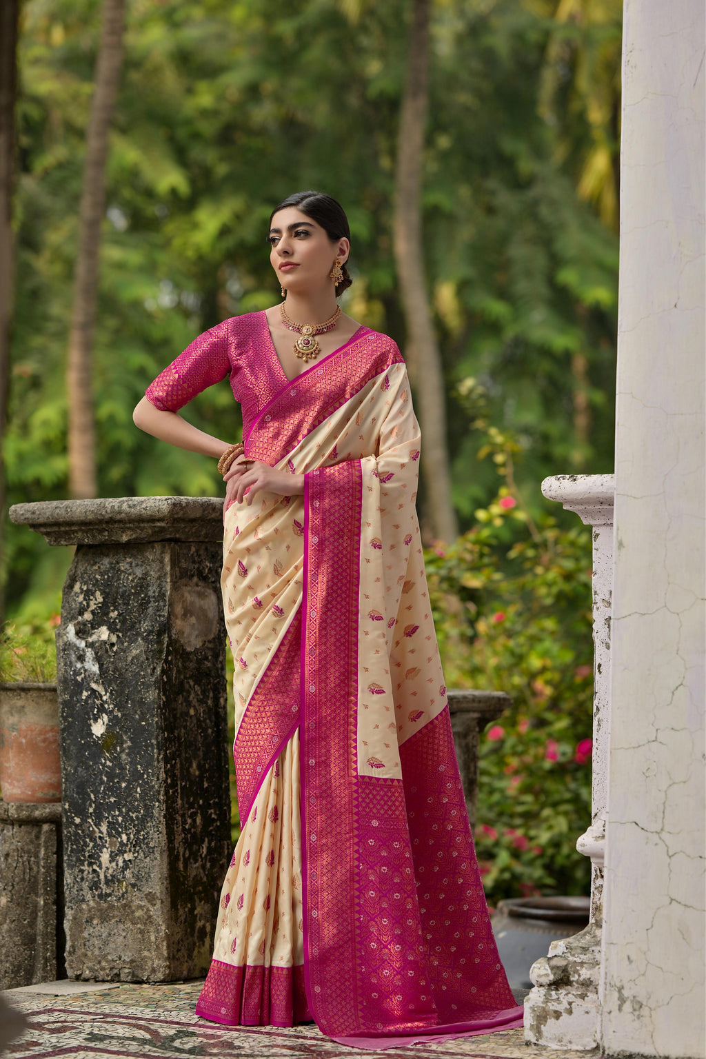 Close up of cream Banarasi silk saree with detailed gold Zari weaving