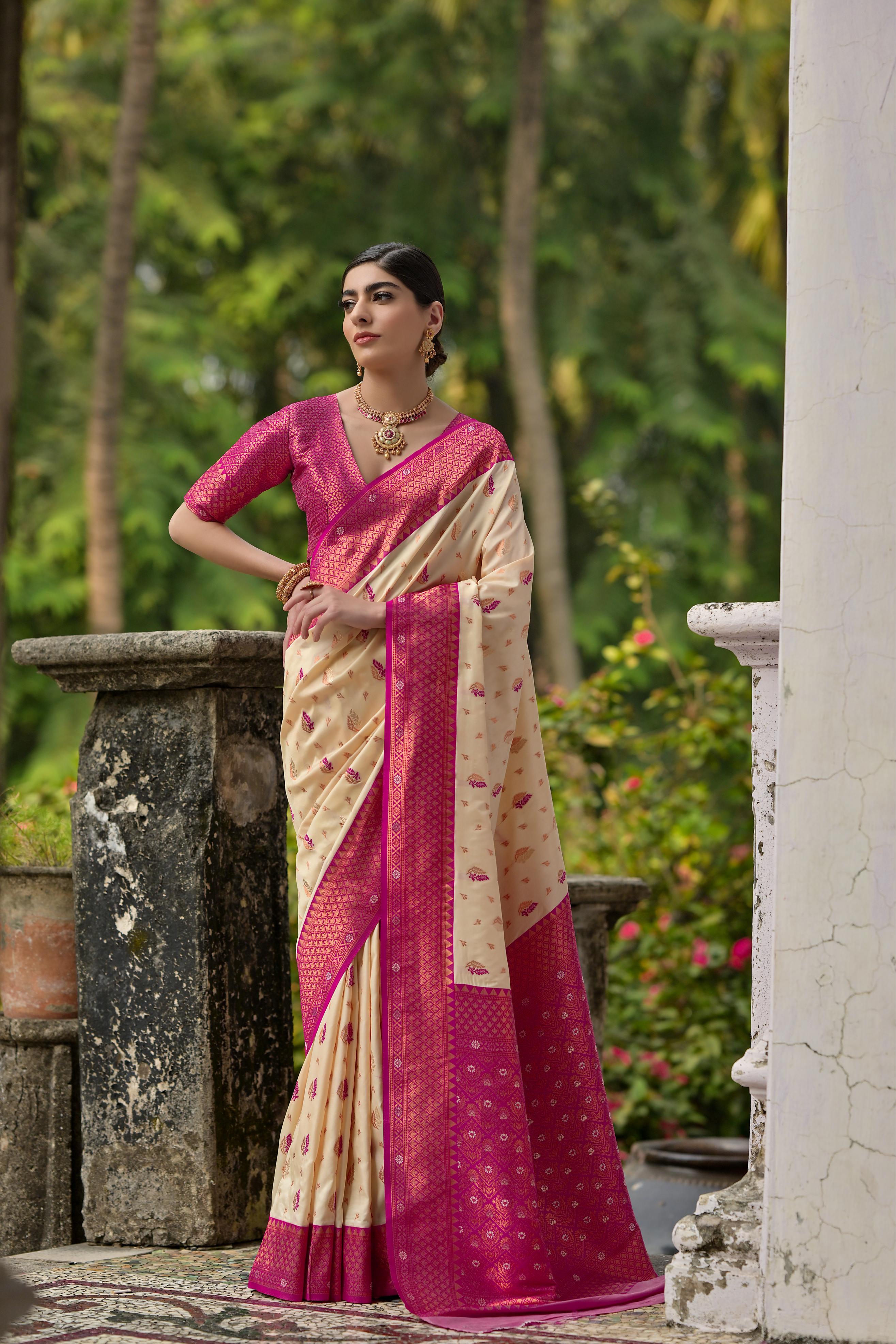 Close up of cream Banarasi silk saree with detailed gold Zari weaving
