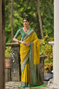 Lemon yellow traditional Banarasi silk saree featuring detailed golden zari woven borders and motifs.