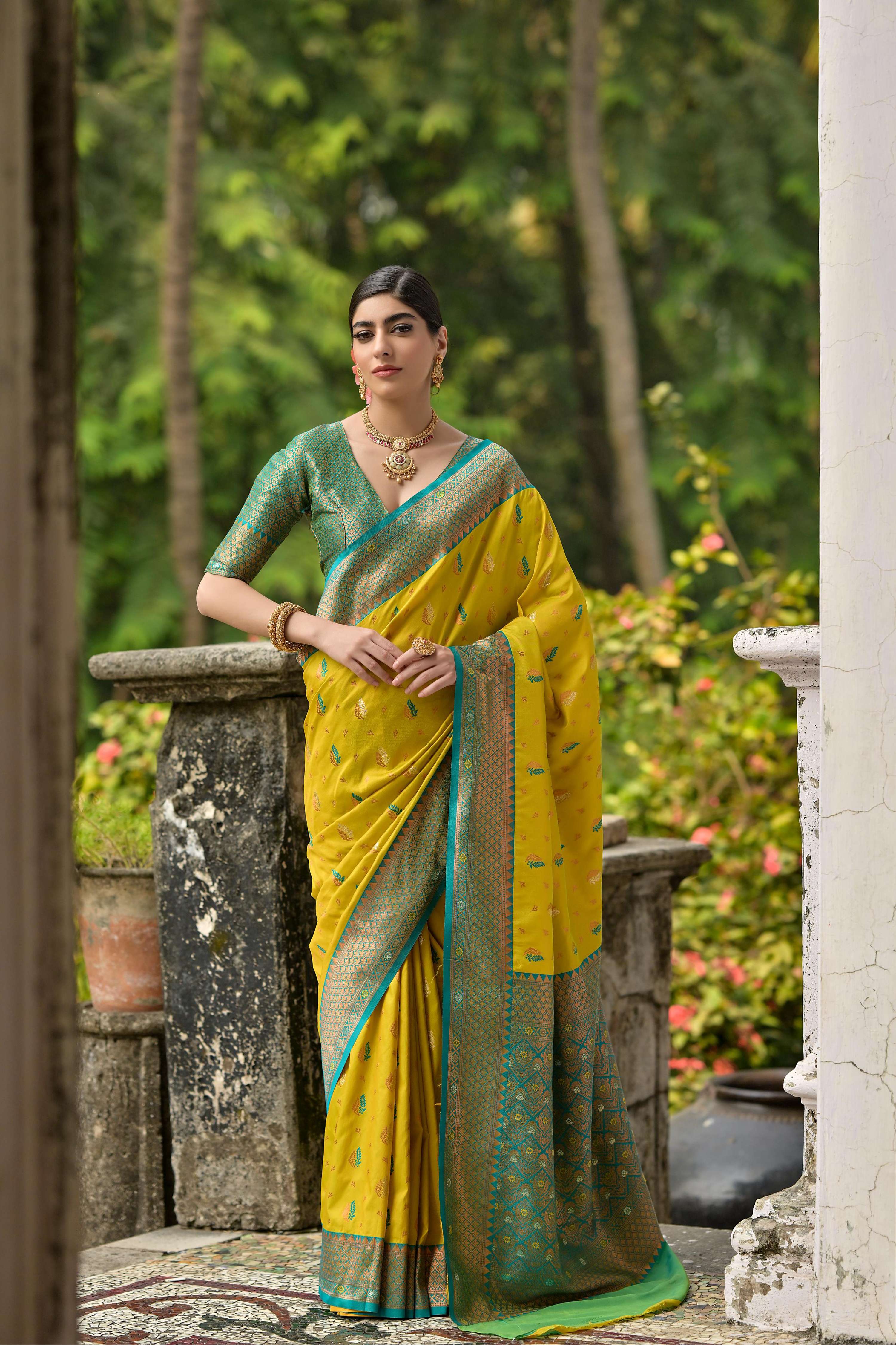 Lemon yellow traditional Banarasi silk saree featuring detailed golden zari woven borders and motifs.