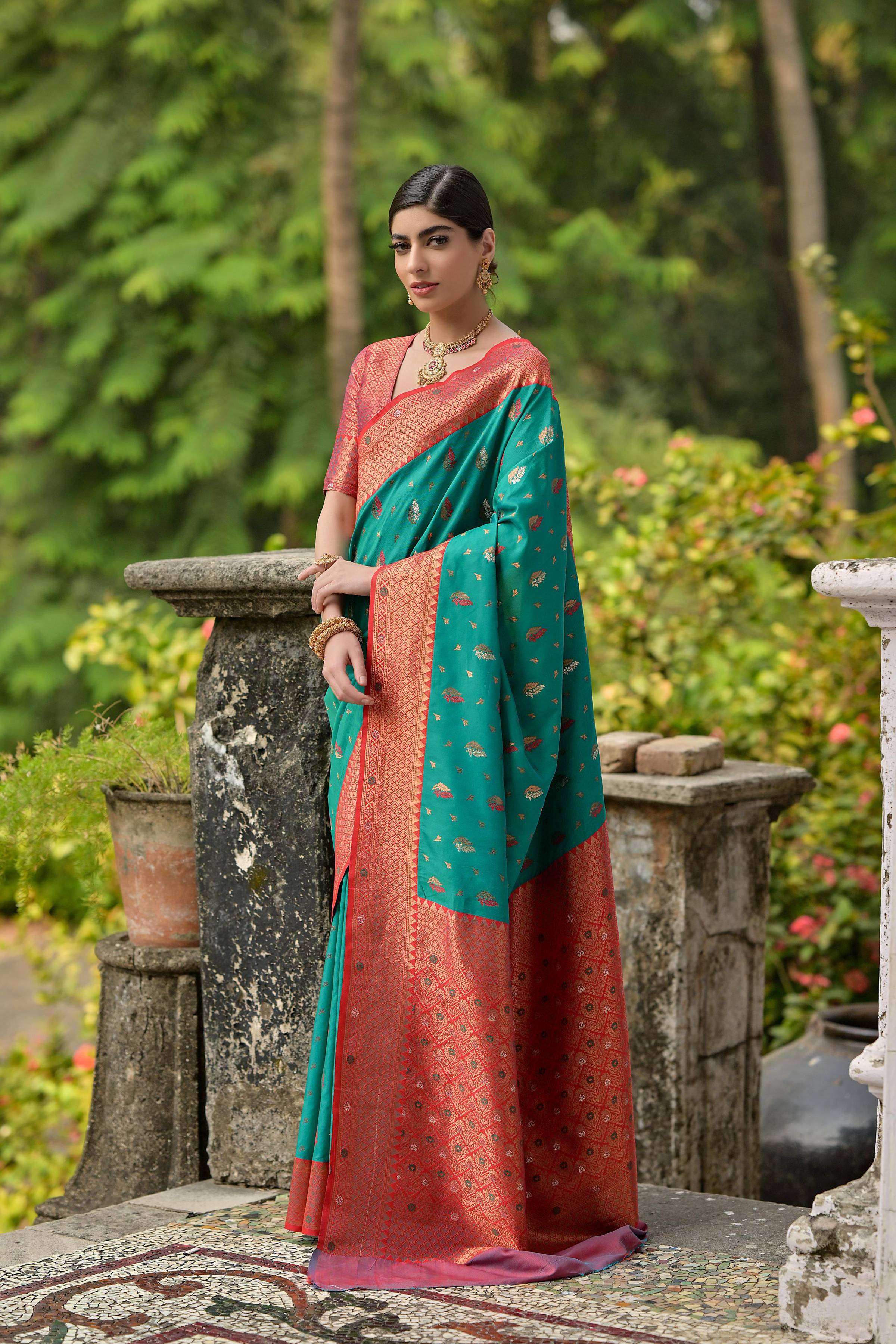 Rama colored Banarasi silk saree with detailed Zari woven border and blouse piece.