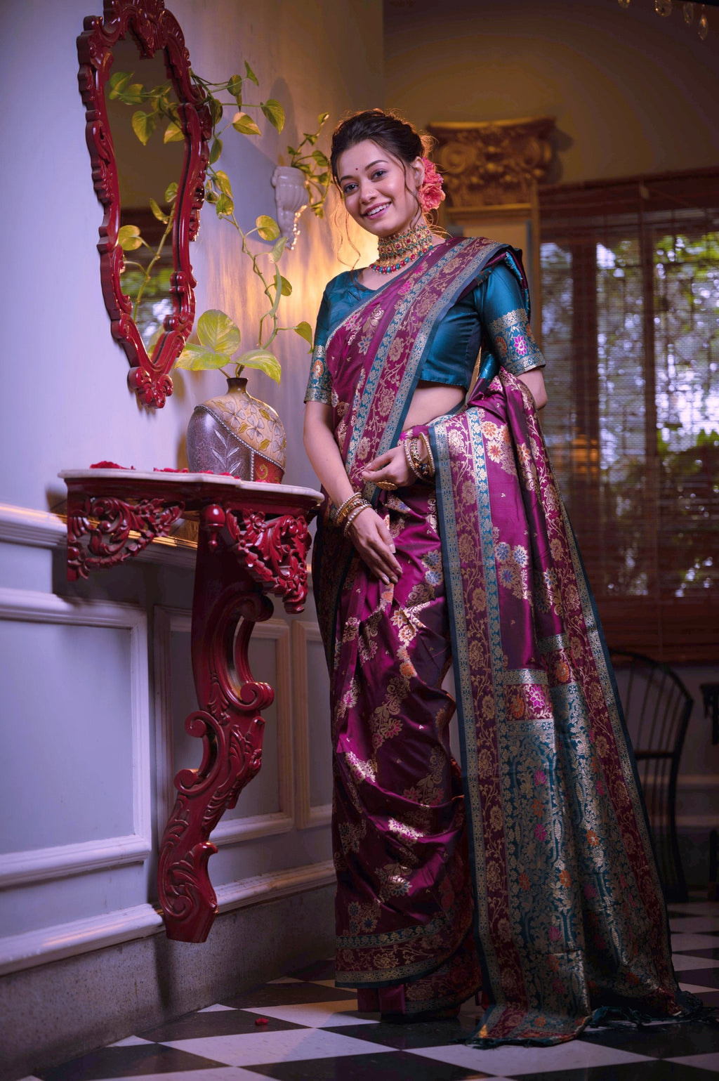 Wine-colored soft Banarasi silk saree with traditional Zari woven motifs and matching blouse.