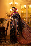 A deep navy blue soft Banarasi silk saree featuring intricate traditional Zari weaving and matching blouse fabric.