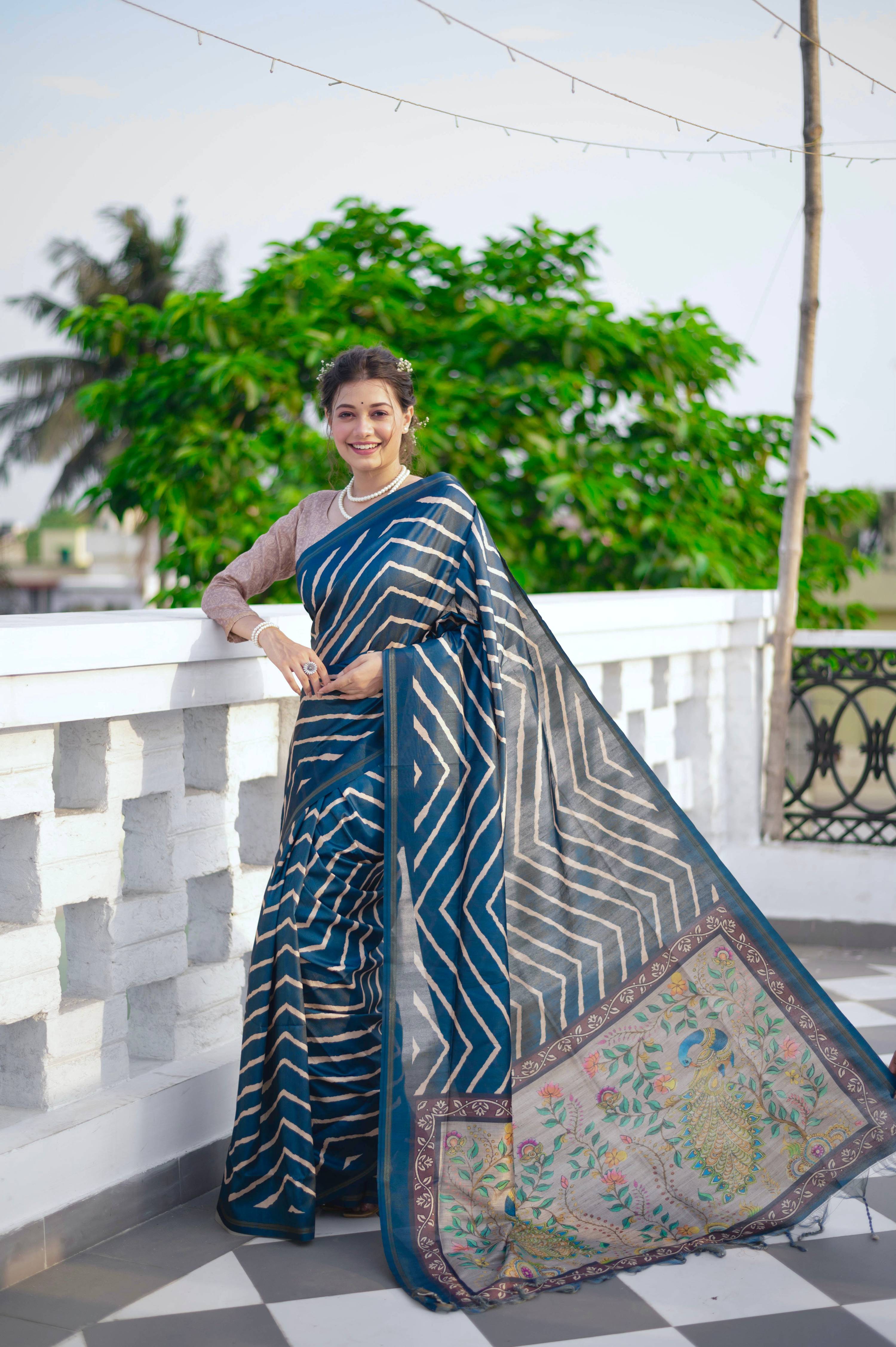 Blue Tussar silk saree featuring a Leheriya print and a decorative zari border with a matching blouse piece