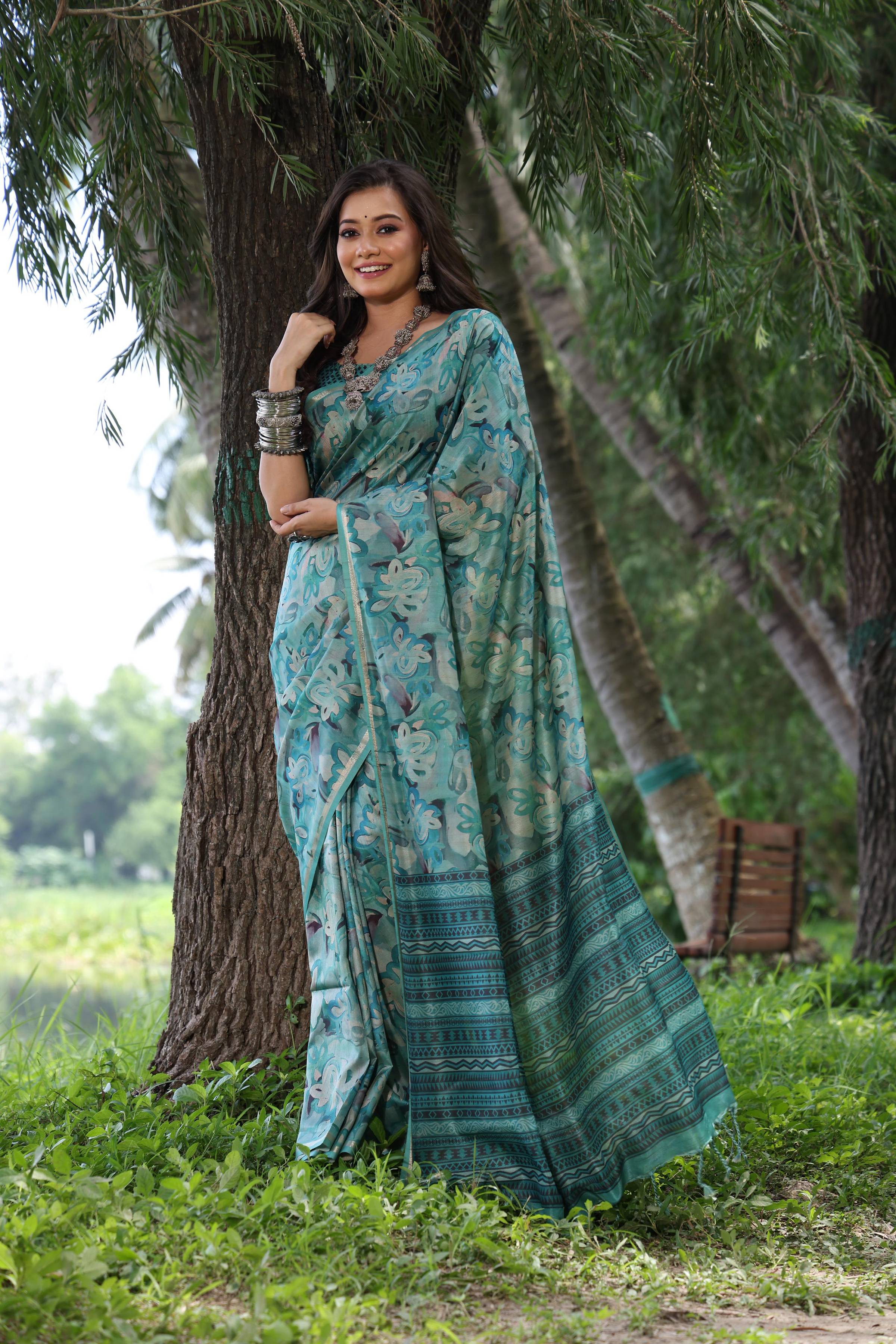 Sky blue soft Tussar silk saree with printed patterns and zari woven border with matching blouse piece