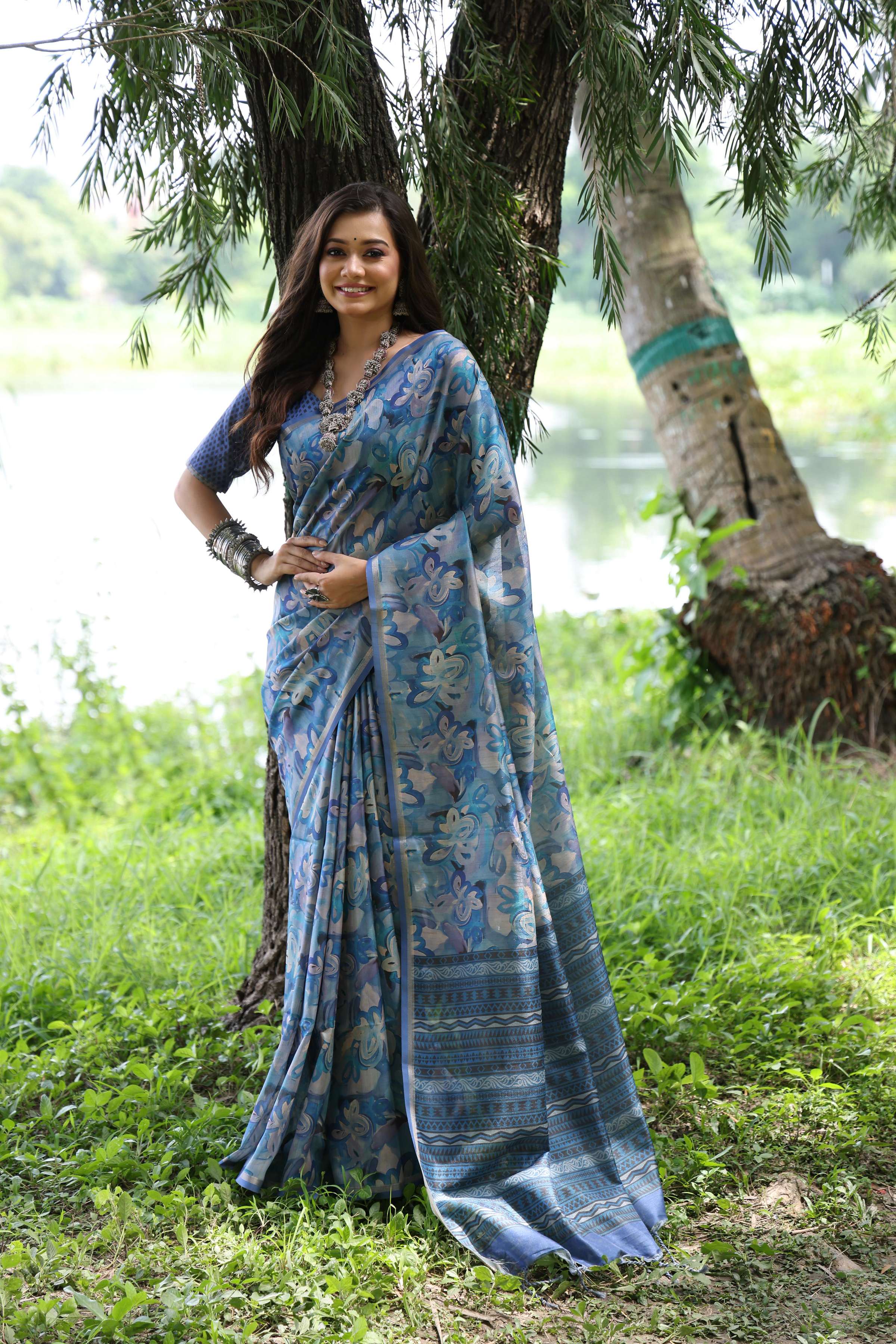 Blue Soft Tussar Silk saree with intricate Zari weaving and elegant floral prints.