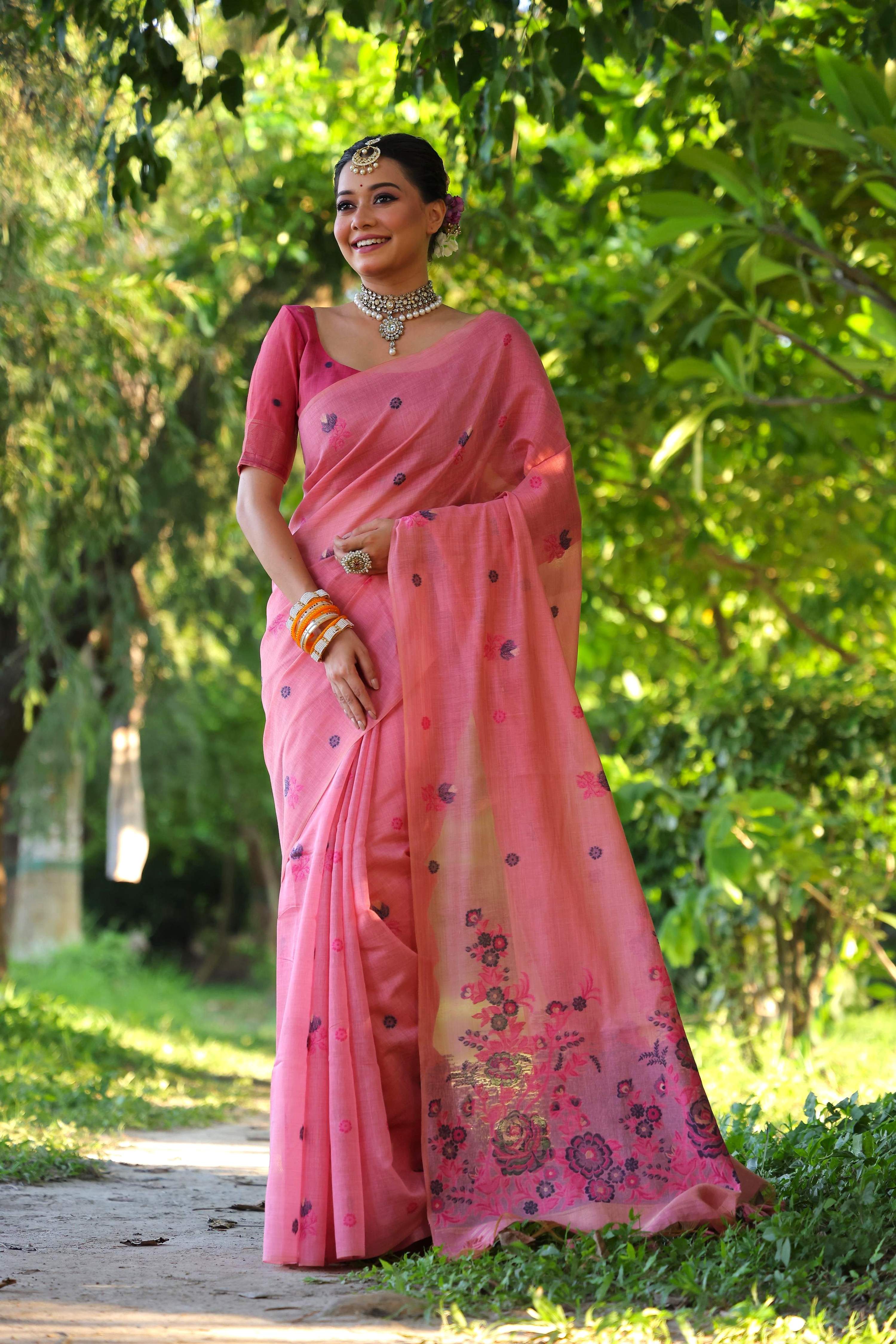 Pink soft Muga cotton traditional saree with floral weaving and matching blouse piece.