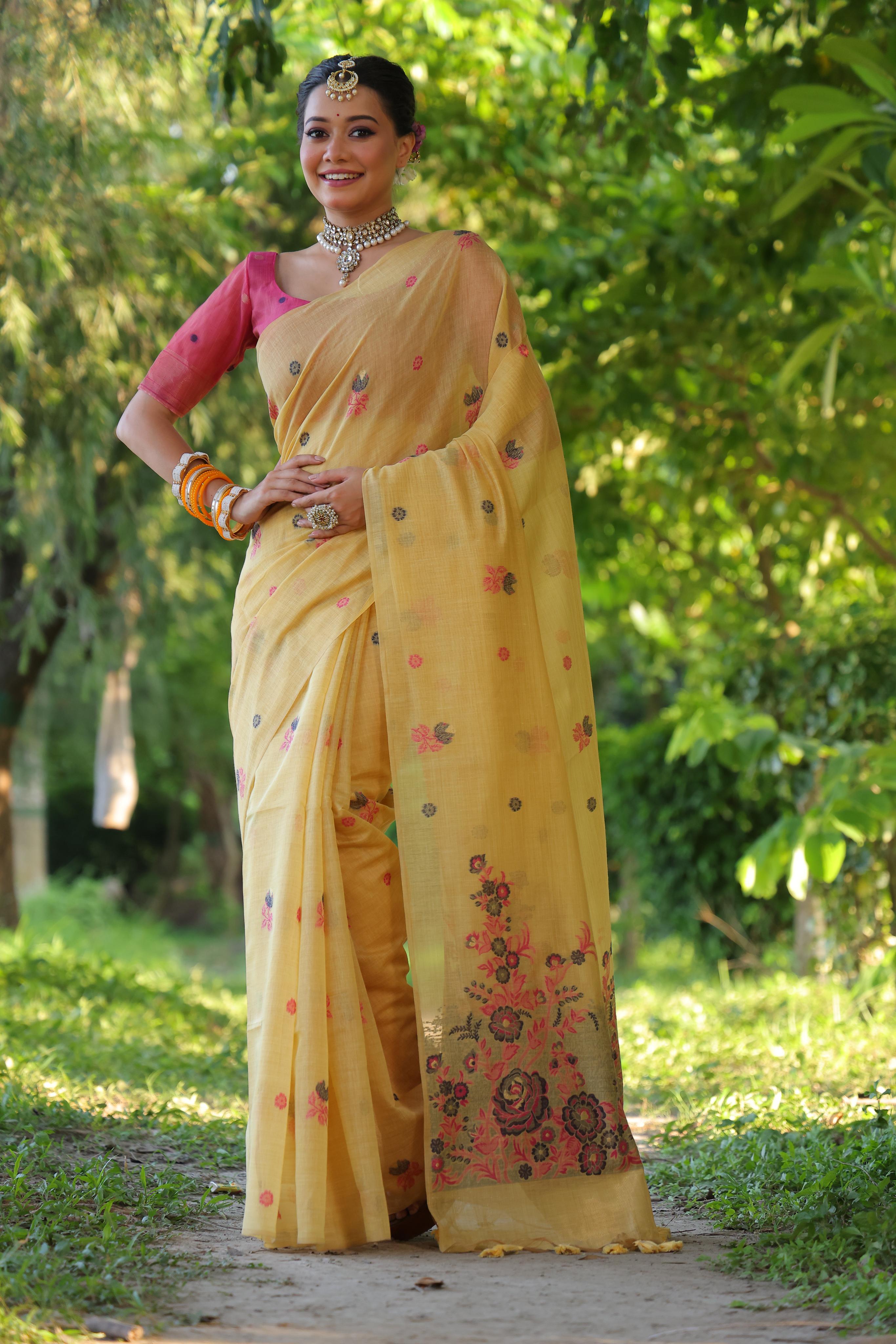 Mustard soft Muga cotton traditional saree with detailed floral weaving and matching blouse.