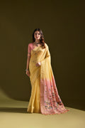 A vibrant yellow soft Muga cotton traditional saree with detailed Resham Zari weaving and matching blouse fabric.