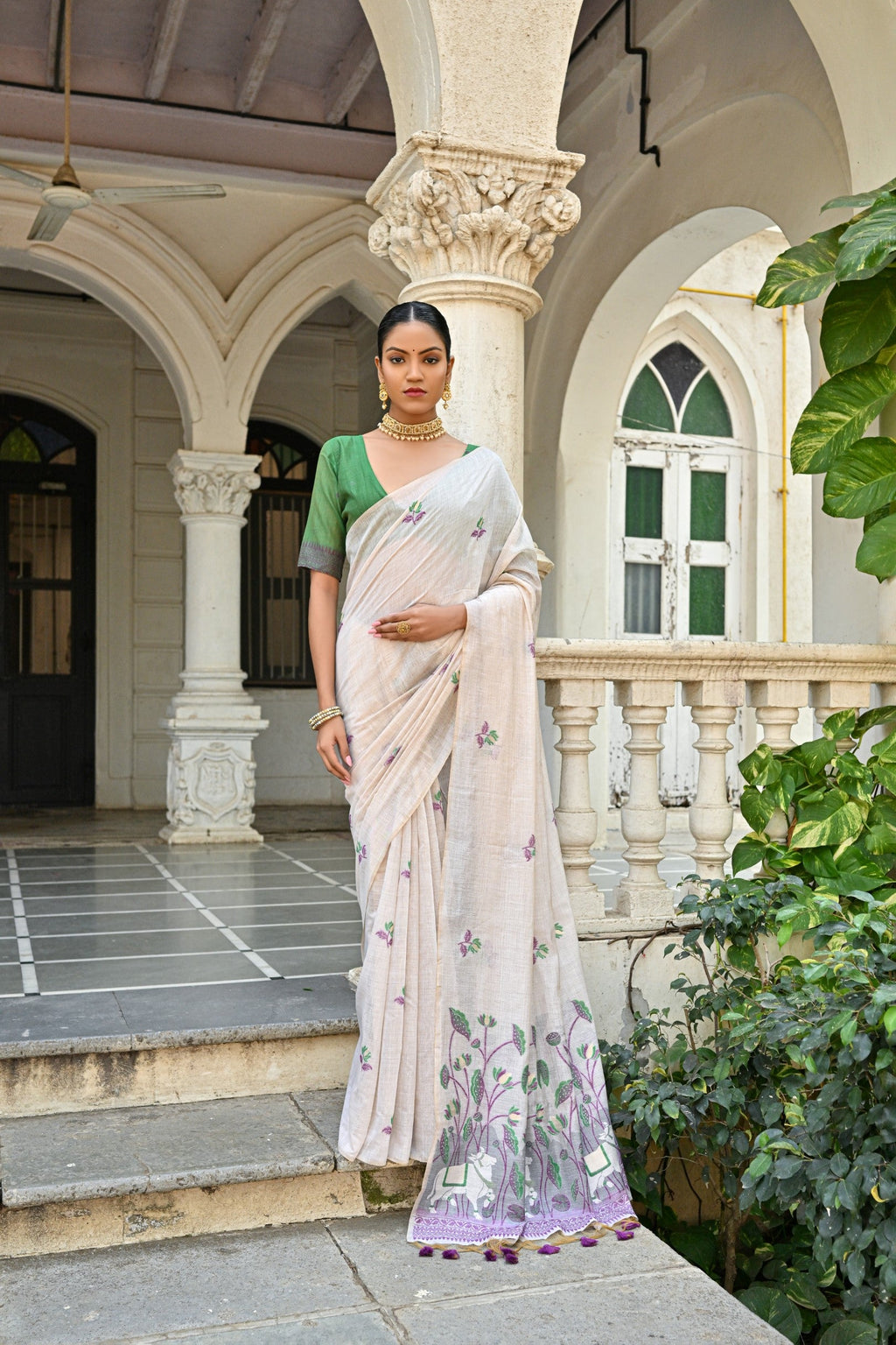 A graceful Wine Muga Cotton saree with intricate floral weaving and a matching blouse.