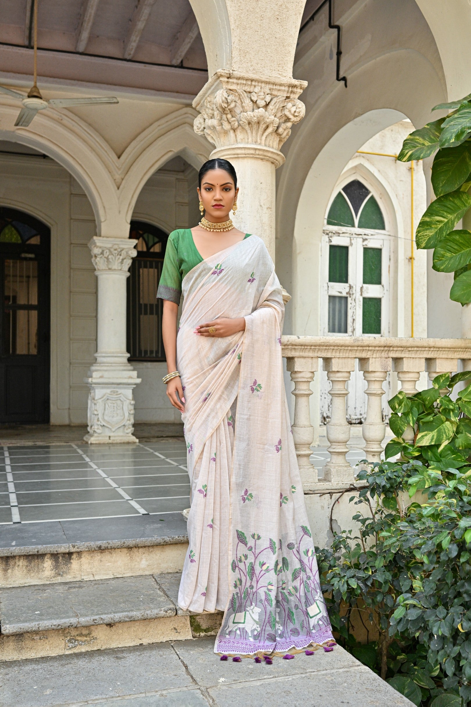 A graceful Wine Muga Cotton saree with intricate floral weaving and a matching blouse.