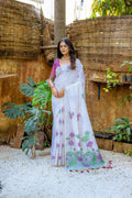 Wine soft Muga cotton saree with intricate floral weaving and matching blouse.