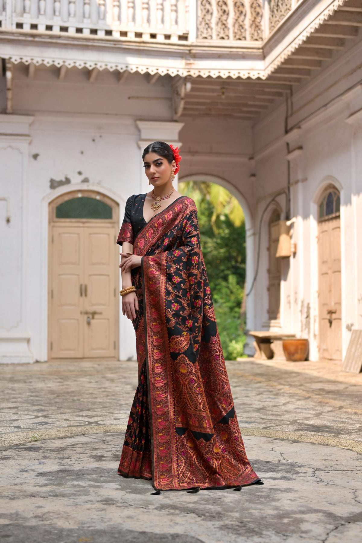 Black soft Pashmina silk saree with intricate Meena Zari weaving and matching unstitched blouse piece.
