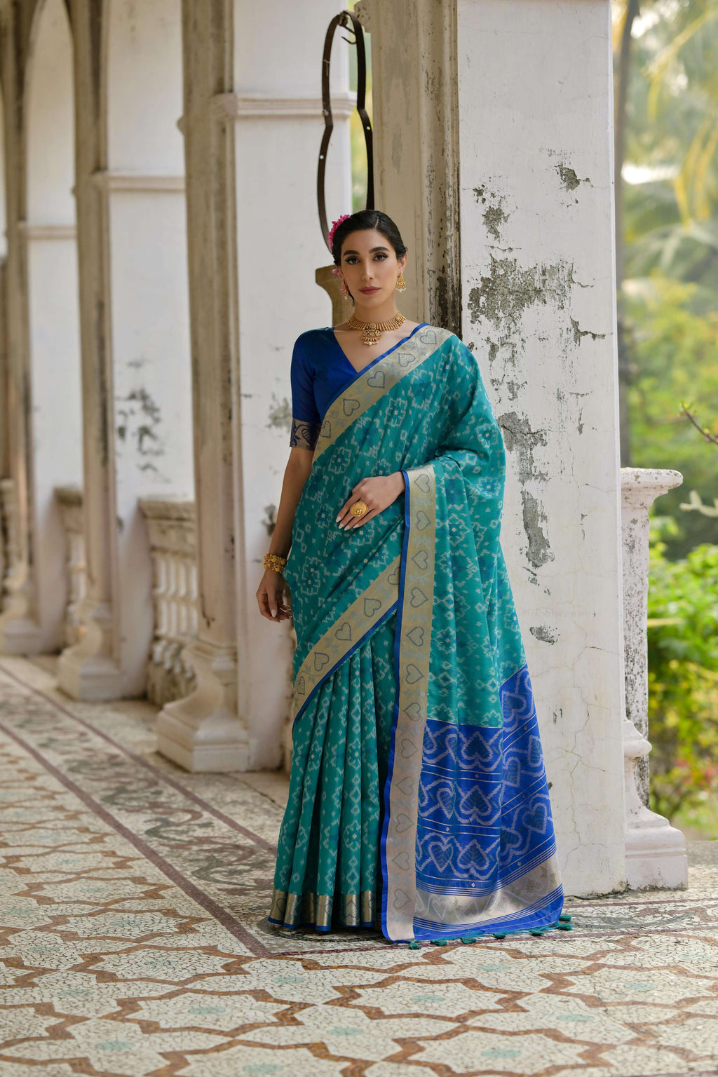Firozi raw silk saree with intricate gold zari woven borders and matching blouse