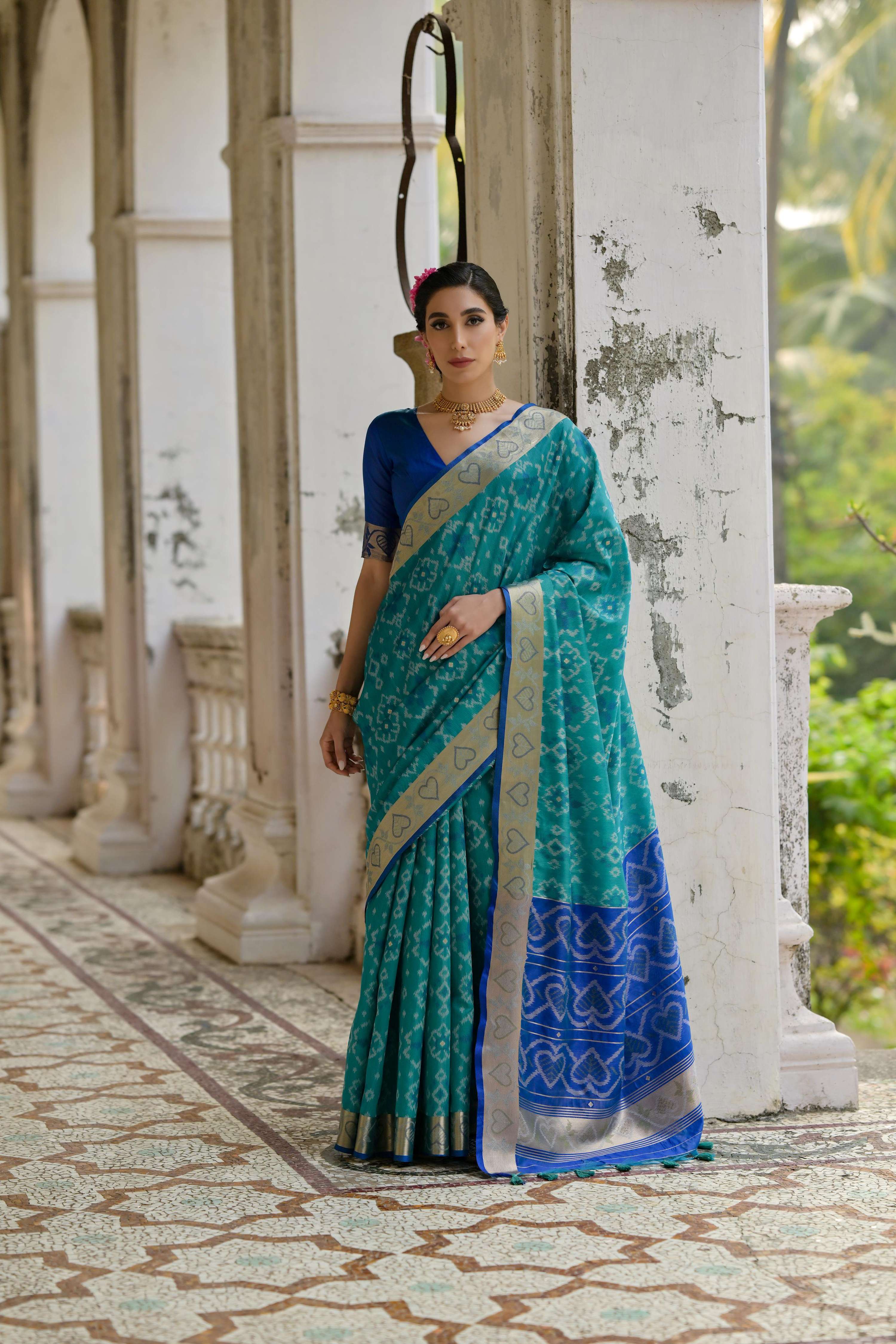 Firozi raw silk saree with intricate gold zari woven borders and matching blouse