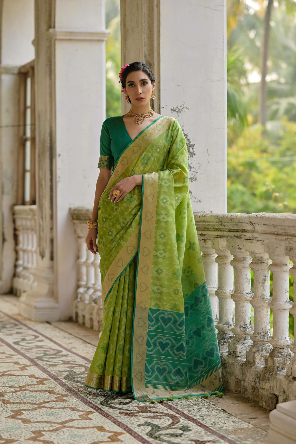 Green soft raw silk saree with intricate gold zari woven details