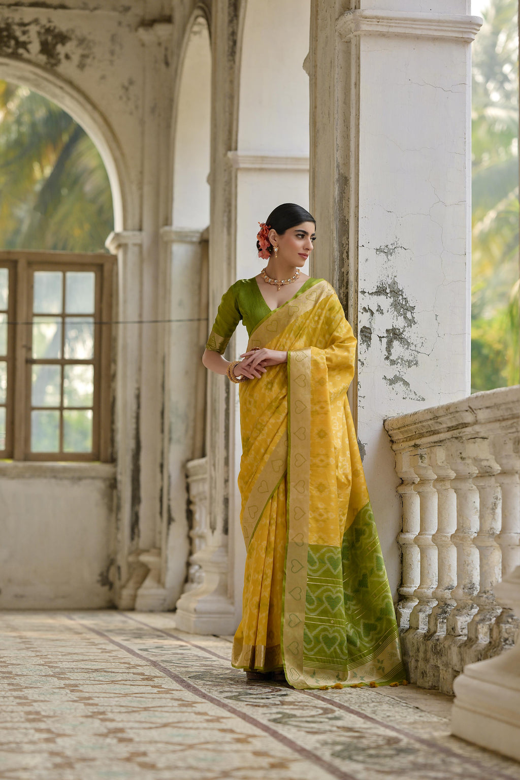 Yellow soft raw silk saree with intricate Zari woven patterns and matching blouse.