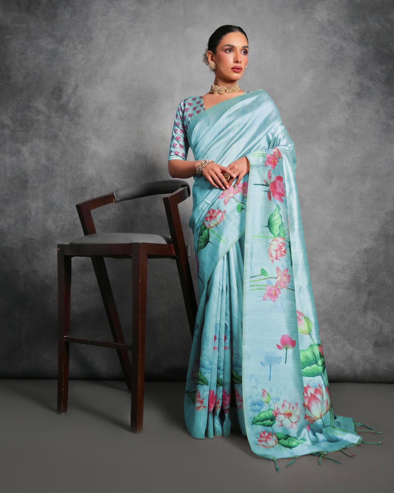 Sky Blue Tussar Silk saree with floral prints and matching blouse fabric.