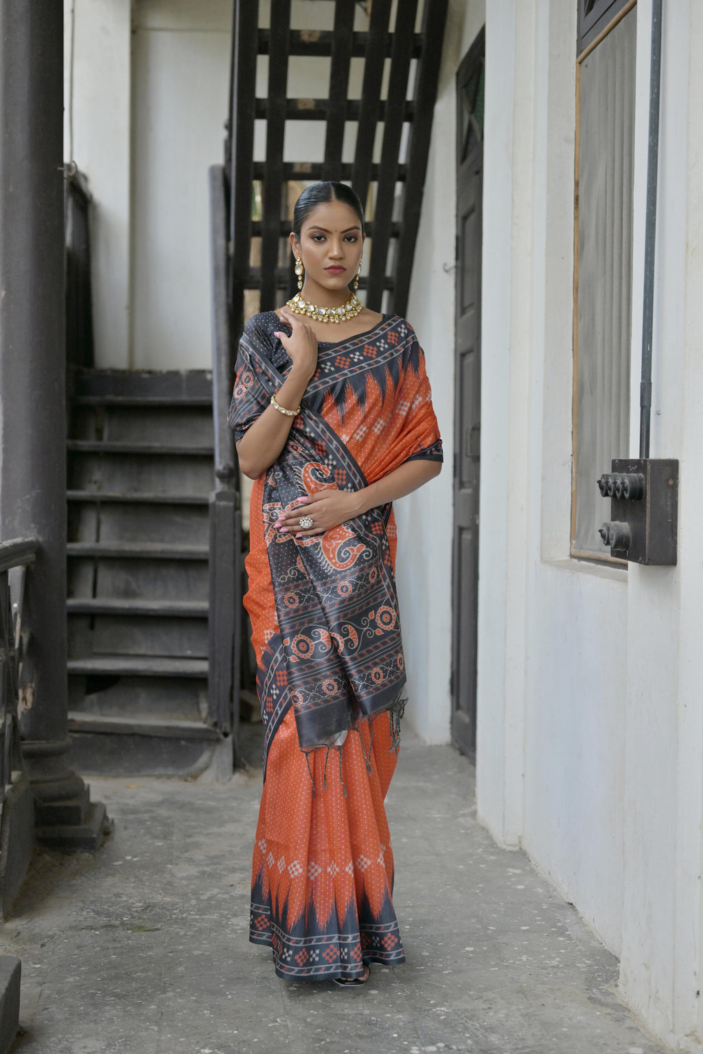 Red soft Tussar silk saree featuring a traditional temple border and Ikkat print